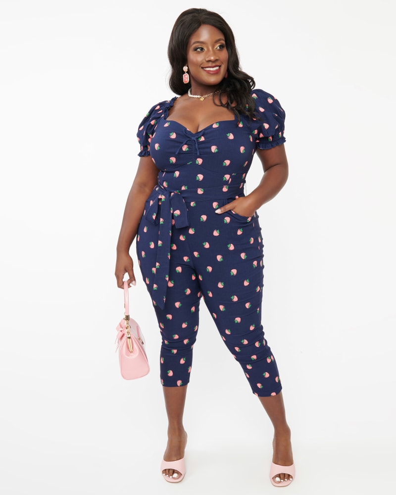 Front of a model wearing a size 3X Unique Vintage Navy & Pink Strawberry Stamp Belted Jumpsuit in Navy & Pink Strawberry Stamp by Unique Vintage. | dia_product_style_image_id:349068